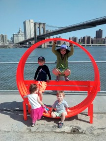 Eliza, her godbrother Kasander and Peter hang out on some art near the Brooklyn bridge